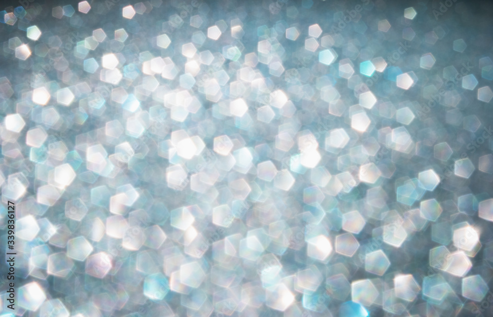 Defocused abstract colorful twinkle light background.  Glittery bright shimmering background use as a design backdrop.