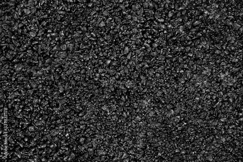 Natural fire ashes with dark grey black coals texture. It is a flammable black hard rock. Space for text. 