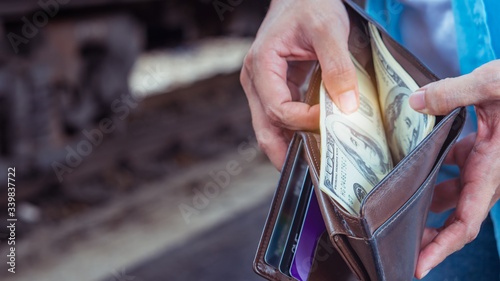 Young woman backpacker traveler hands holding wallet dollar currency money plan to saving spend budget for holiday buy cheap discount deals travel promotion trip after coronavirus empty tourist crisis