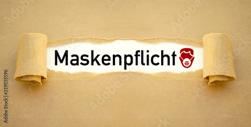 Brown paper work red face mask and with the german word for message face mask duty - maskenpflicht