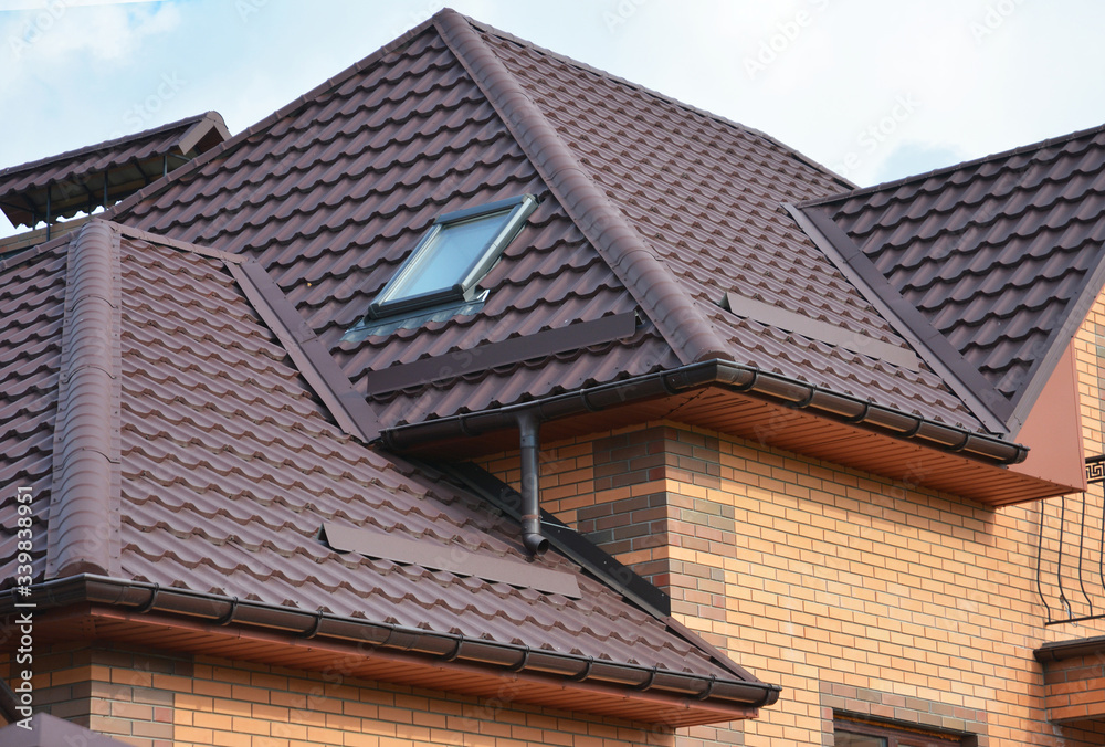 Complex roof design, metal tiled expensive roofing construction with a