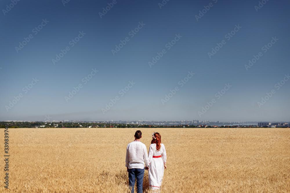 girl with a guy in a dress in wheat