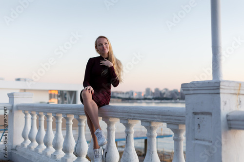 blonde model at the sea on sunset