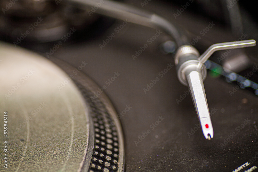 Close up of the arm of a modern turn table as part of a dj set Close up of the arm of a modern turn table as part of a dj set