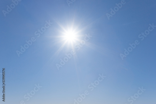 hot sparkle sun on a blue sky  outdoor summer sky background