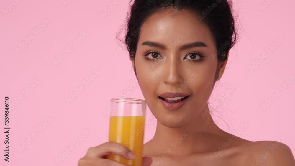 Beautiful asian girl drinking orange juice. Pretty girl holding glass fruit juice and detox drink. Concept of beverage, healthcare, food and drink. Beautiful asian girl drinking orange juice. Pretty girl holding glass fruit juice and detox drink. Concept of beverage, healthcare, food and drink.