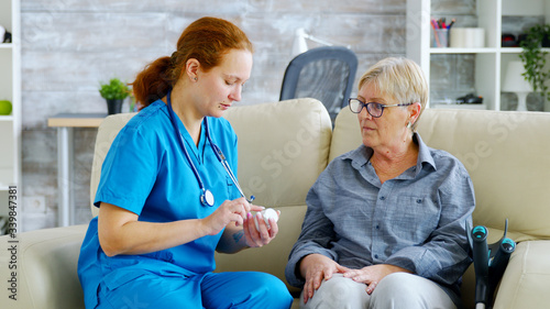 Female doctor consultin a senior woman about pills dosage and subscription photo