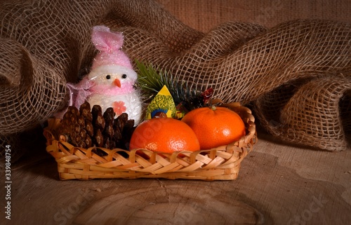 New Year's still-life with tangerines, chocolate and a fur-tree branch