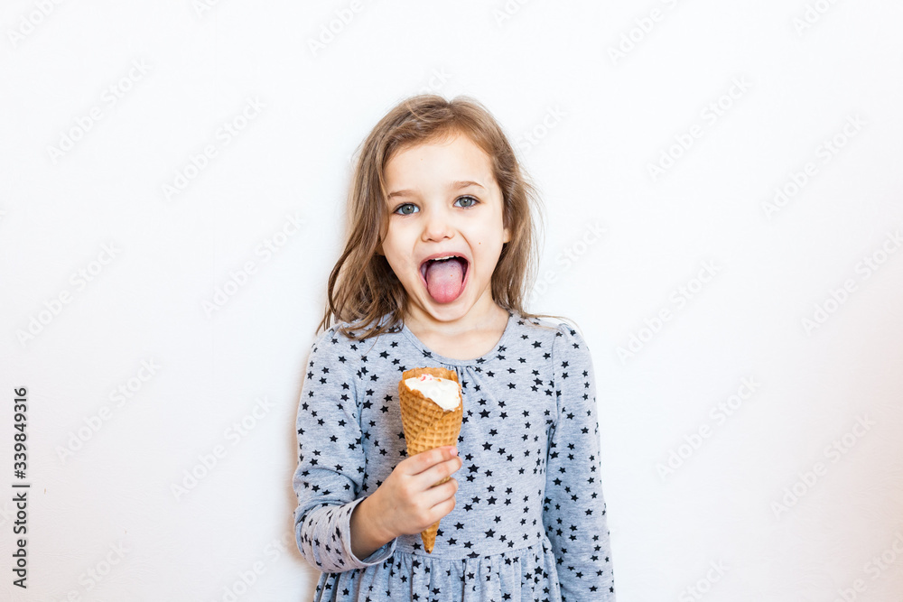 Girl eating ice cream at home during quarantine, together with her sister cold sweetness, joy, child, childhood Girl eating ice cream at home during quarantine, together with her sister cold sweetness, joy, child, childhood