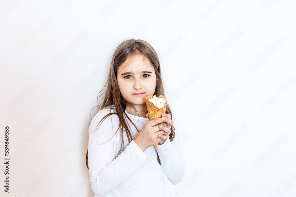Girl eating ice cream at home during quarantine, together with her sister cold sweetness, joy, child, childhood Girl eating ice cream at home during quarantine, together with her sister cold sweetness, joy, child, childhood