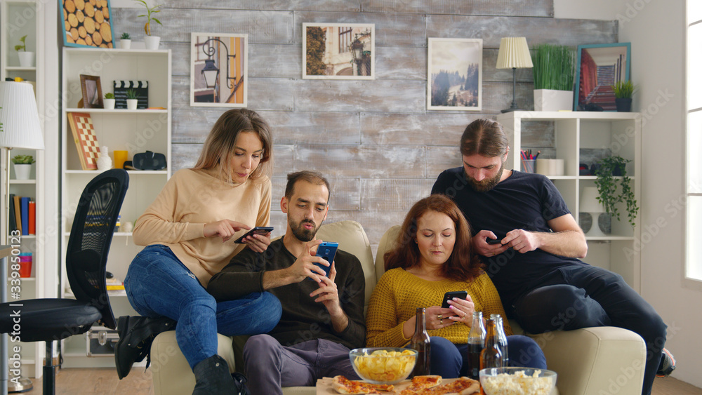 Friends on phones in cozy bright living room