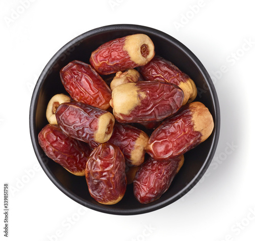 Bowl of dates isolated on white, from above