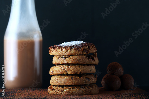 Chocolate cookies on wooden table. Chocolate chip cookies shot.. cookies look like very delicious with milk and chocolate balls (ID: 339854738)