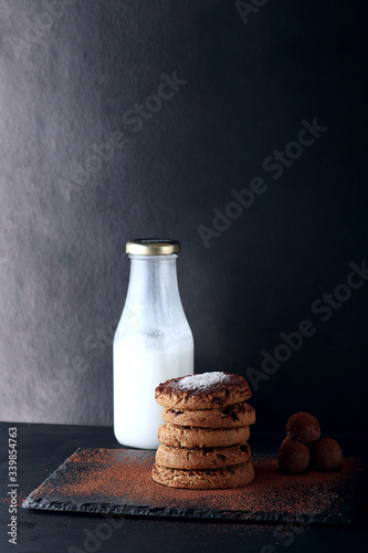 Chocolate cookies on wooden table. Chocolate chip cookies shot.. cookies look like very delicious with milk and chocolate balls (ID: 339854763)