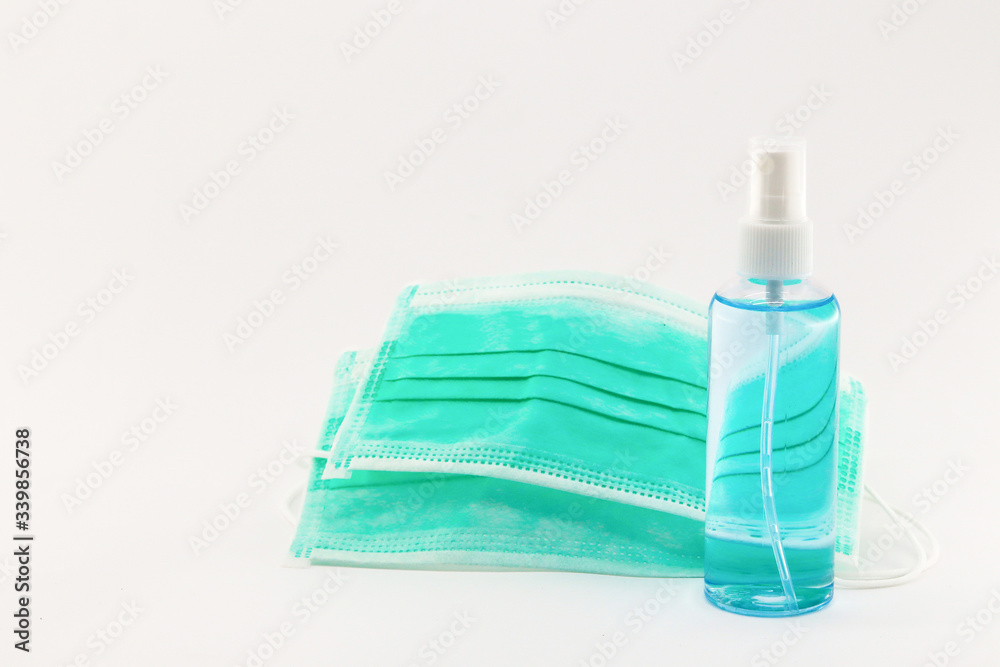 mask and alcohol spray on white background. 