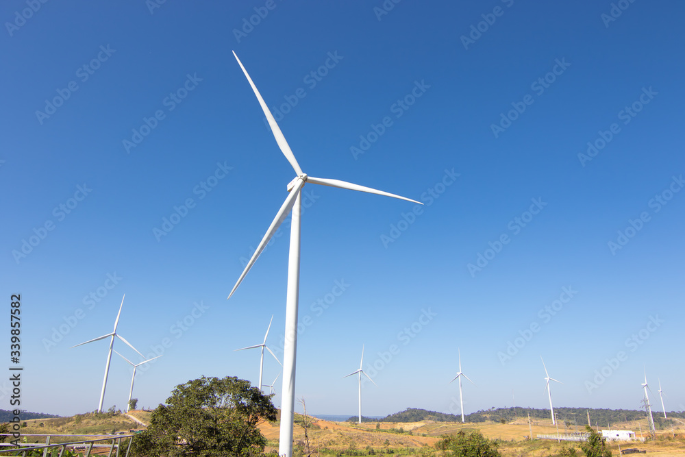 Beautiful green meadow with Wind turbines and sky generating electricity in Thailand Beautiful green meadow with Wind turbines and sky generating electricity in Thailand
