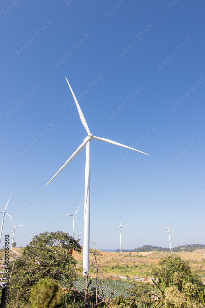 Beautiful green meadow with Wind turbines and sky generating electricity in Thailand Beautiful green meadow with Wind turbines and sky generating electricity in Thailand