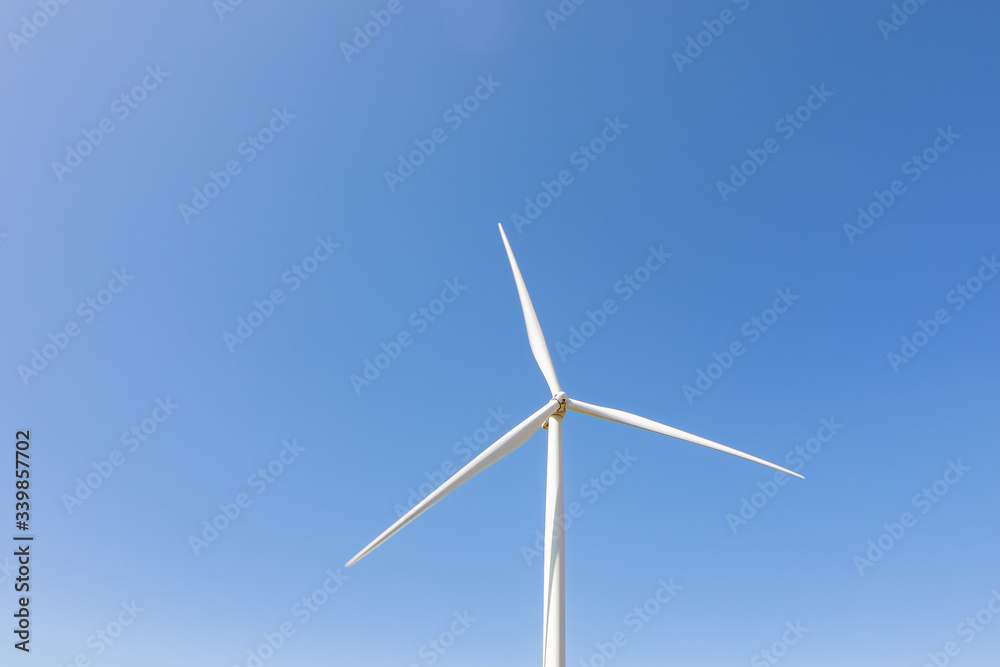 Beautiful green meadow with Wind turbines and sky generating electricity in Thailand Beautiful green meadow with Wind turbines and sky generating electricity in Thailand