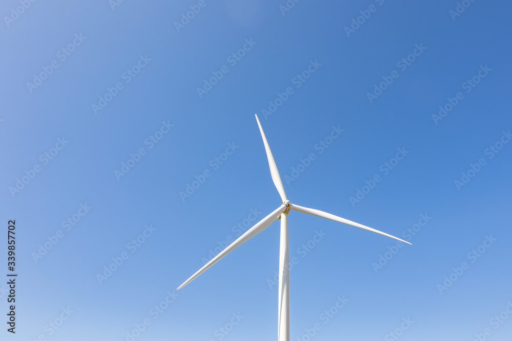 Beautiful green meadow with Wind turbines and sky  generating electricity in Thailand