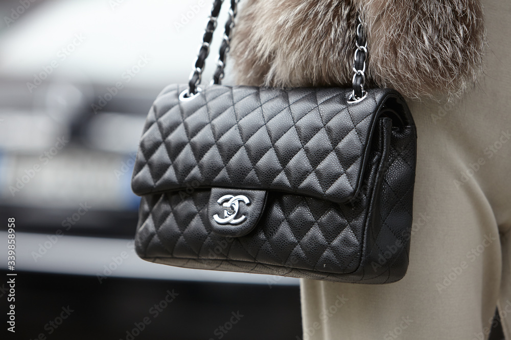 Woman poses for photographers with Chanel bag on February 27, 2015 in  Milan, Italy foto de Stock | Adobe Stock