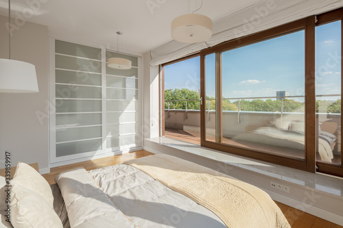 Elegant bedroom with window wall photo