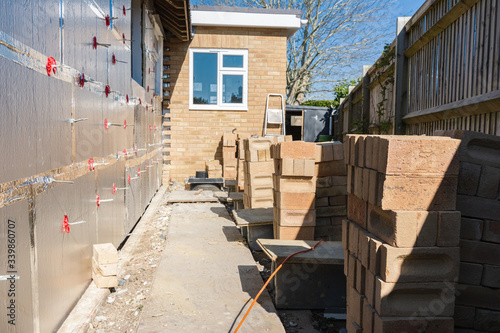 Preparation of the insulated wall for bricklaying in residential property, renovation project, rows of bricks, selective focus