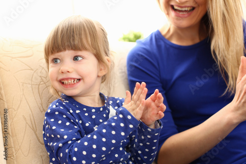 Cute little girl play with mom pat-a-cake at home portrait. Love care friendship parrent casino lottery win kindergarten party teacher celebration group opportunity great social promotion photo