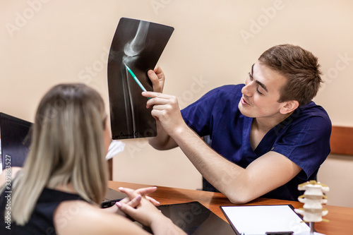 Portrait of doctor examining radiogram picture. Smiling physician pleased with results of treatment. Medicine and health care concept. diagnostics of traumatologist