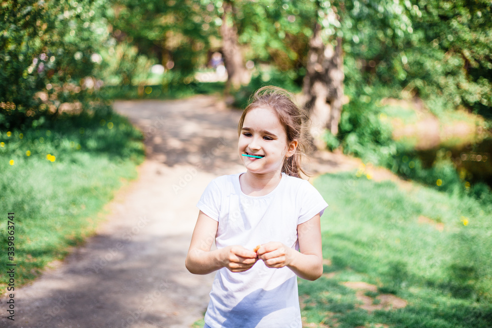 Girl walking on a path in a forest or Park, vacation, travel, vacation, summer, vacation, school, out of school Girl walking on a path in a forest or Park, vacation, travel, vacation, summer, vacation, school, out of school