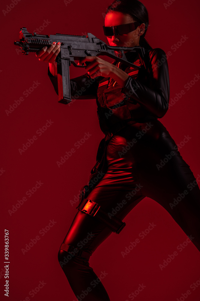 futuristic african american woman in glasses aiming assault rifle on red background futuristic african american woman in glasses aiming assault rifle on red background