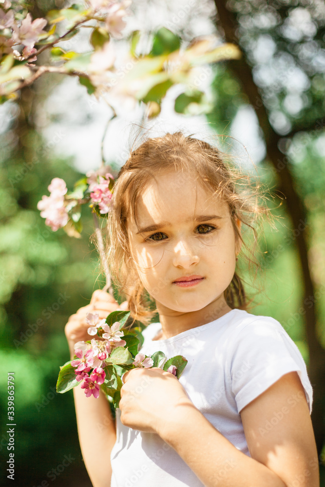 Girl spring branches of a flowering Apple tree, beauty and youth, portrait in flowering branches, trees, walk in the Park, rest Girl spring branches of a flowering Apple tree, beauty and youth, portrait in flowering branches, trees, walk in the Park, rest