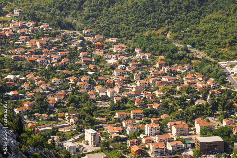 Red roofs of houses and buildings, village near Kotor in Montenegro, aerial view.