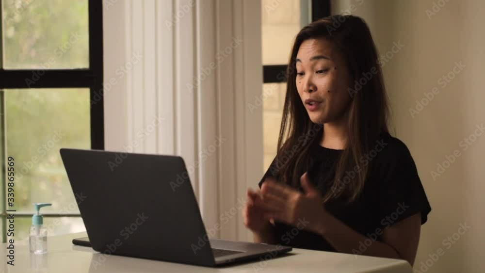 Online work conference on laptop asian lady working from home. Stay home for coronavirus protection. Skype with family in long distance. Online work conference on laptop asian lady working from home. Stay home for coronavirus protection. Skype with family in long distance.