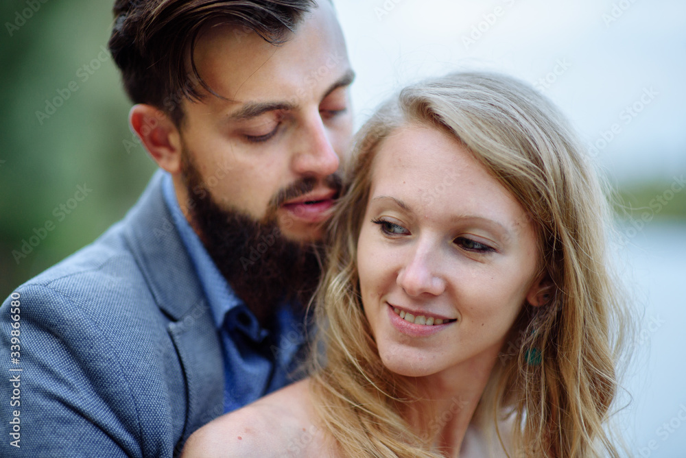 Close up portrait of happy couple. Curley smart girl and bearded handsome man