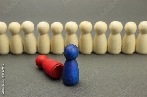 Wooden figures of people. Battle of leaders before the formation of a business team