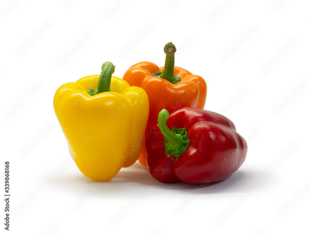 Red, yellow, and orange bell peppers isolated on white background Red, yellow, and orange bell peppers isolated on white background