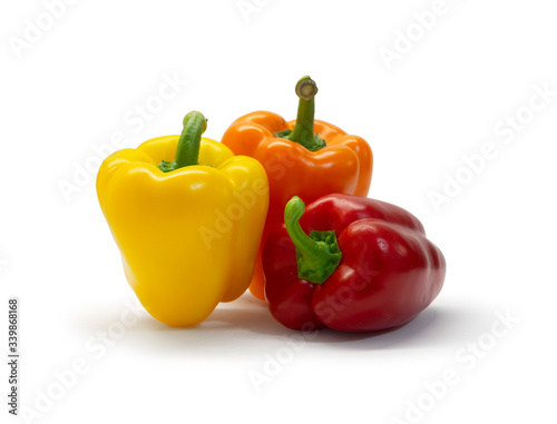 Red, yellow, and orange bell peppers isolated on white background