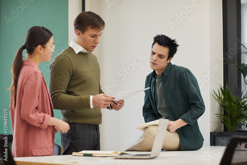 Group of business people planning work in team at the table and reading documents at office