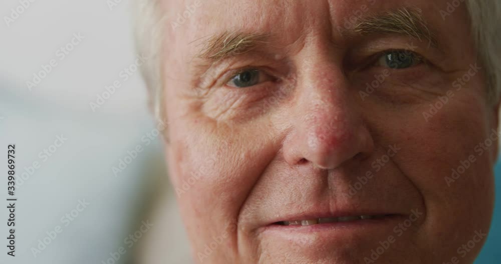 Senior man in social distancing smiling at camera Senior man in social distancing smiling at camera