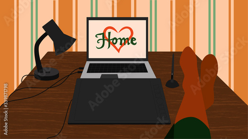 Young female artist taking time out to relax at home sitting with her feet in long socks up on a table at the laptop and tablet. Signature Home on the screen