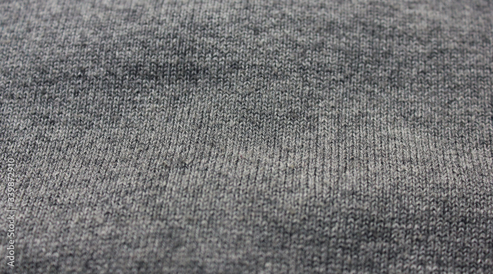 Creased gray woven fabric texture. Wavy grey textile, rough thread canvas clothes, warm jacket or hoodie material background. Fashion clothes design, simple classic grey color shirt detailed view Creased gray woven fabric texture. Wavy grey textile, rough thread canvas clothes, warm jacket or hoodie material background. Fashion clothes design, simple classic grey color shirt detailed view