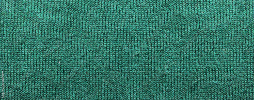 Woven fabric pattern background. Empty dark faded green color texture, thread textile pattern of casual clothing design. Blank green color fabric backdrop