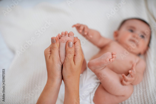 Close-up of children's foot massage on the bed.