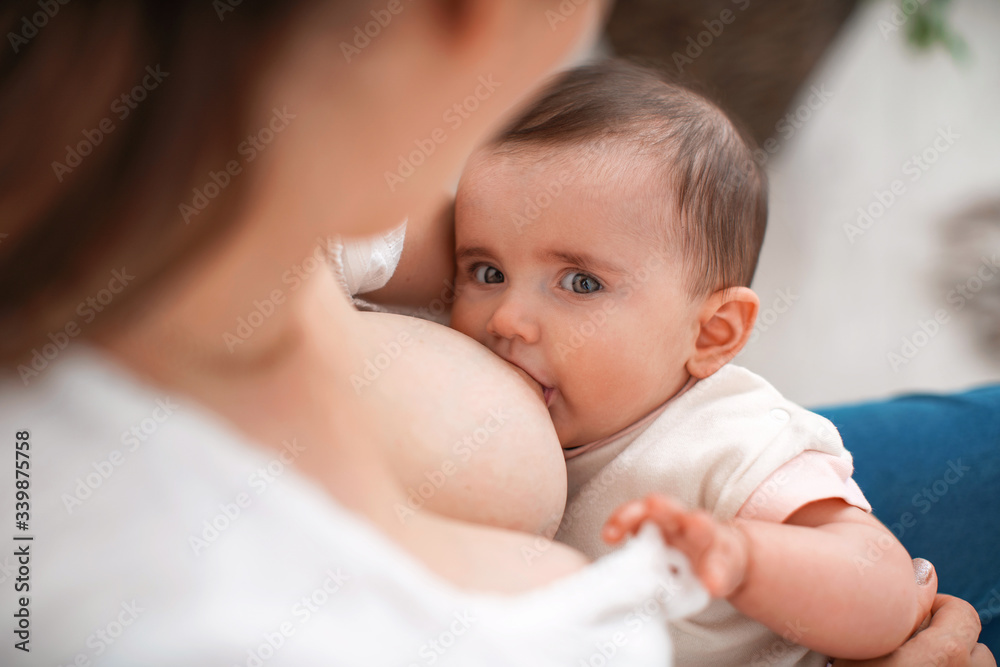 Process of breastfeeding. Mother is breastfeeding a child. Process of breastfeeding. Mother is breastfeeding a child.