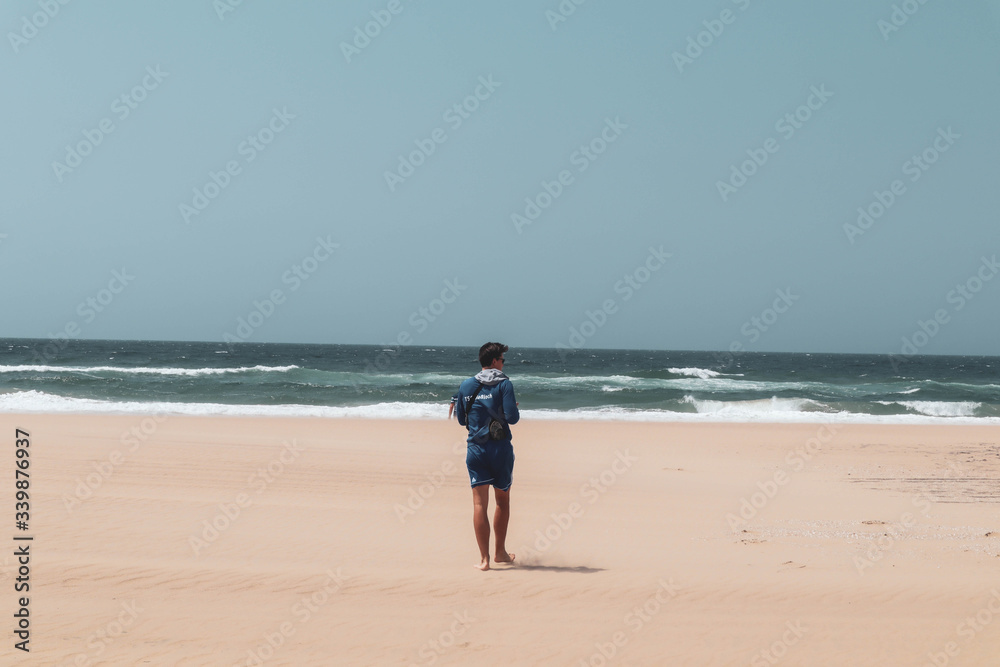 man walking on the beach