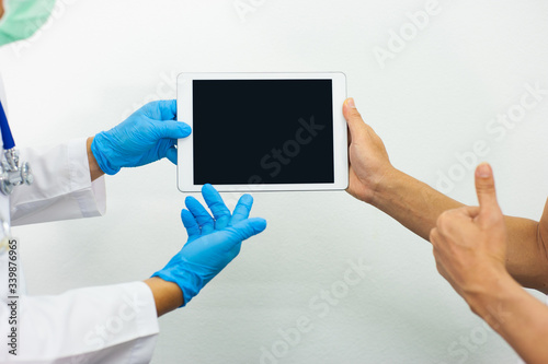 Concepts of annual health checkup. The doctor held the tablet on a blank screen.