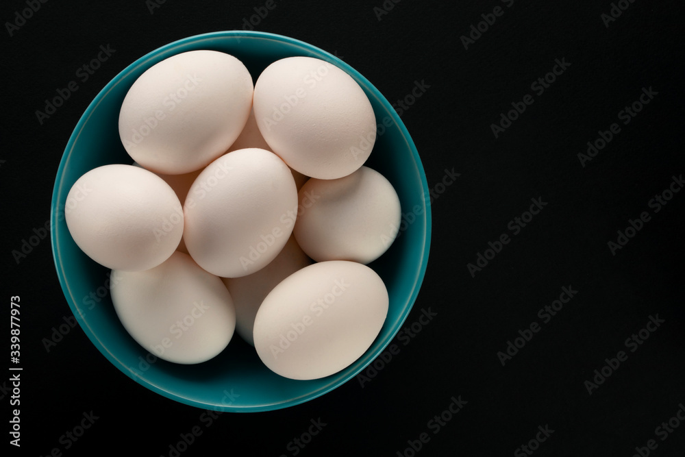 Chicken eggs on the table on black background Chicken eggs on the table on black background