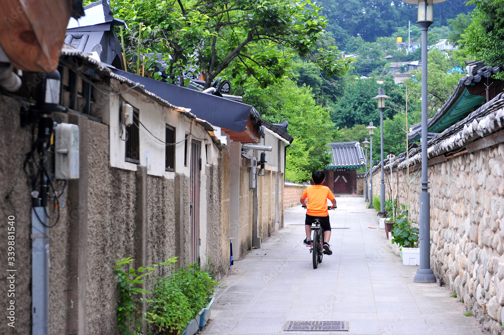 Korean children Riding Bicycles in the Alley of Hanok Village, Jeonju, South Korea.