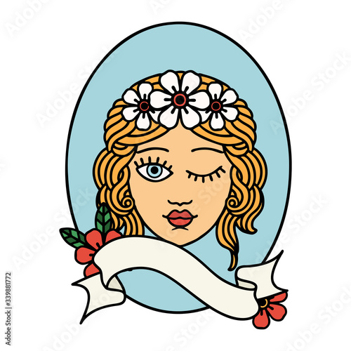tattoo with banner of a maiden with crown of flowers winking