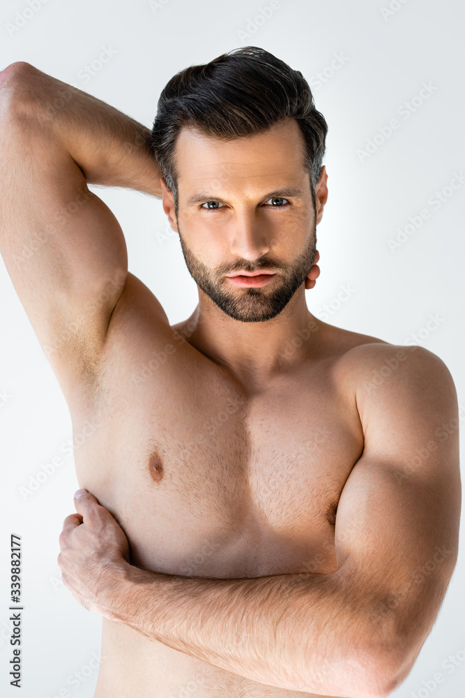 Fototapeta premium handsome and shirtless man looking at camera isolated on white